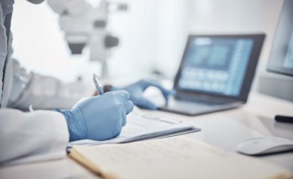 A researcher recording data