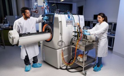Image: Glenn Hunt two researchers looking at a large machine