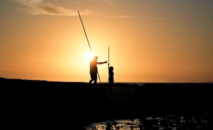 Image: Rafael Ben-Ari, Getty Images Silhouette of two people spear fishing