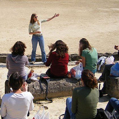 Dr Amelia Brown lecturing at an ancient stadium in Nemea, Greece Dr Amelia Brown lecturing at an ancient stadium in Nemea, Greece